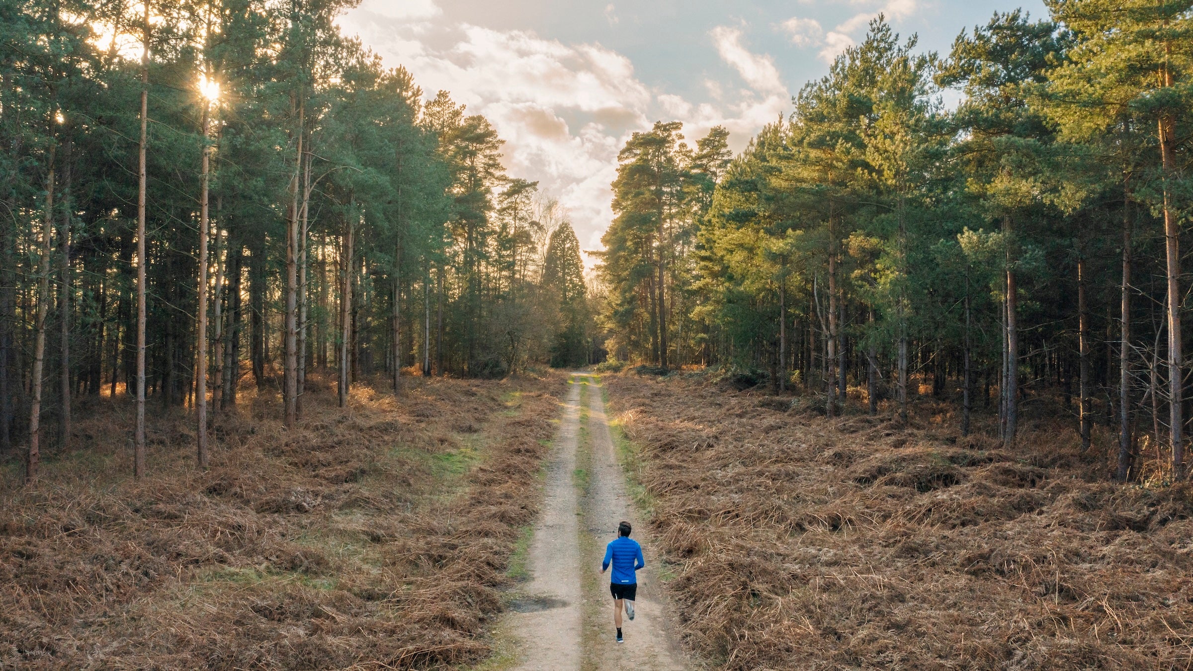 man running through woods